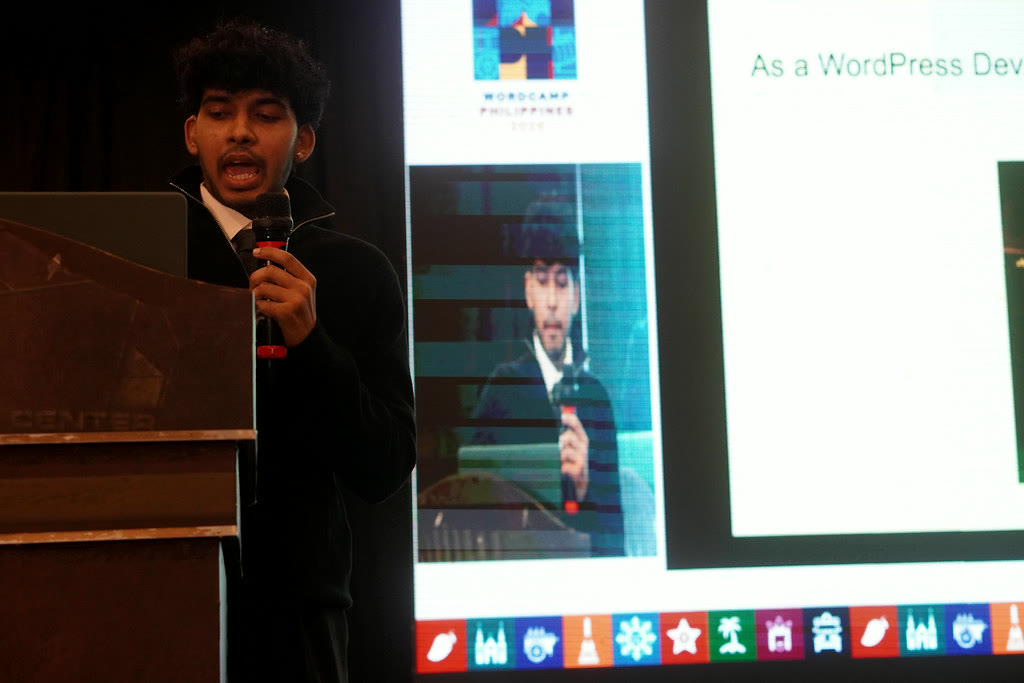 Yash Singh at the lectern with a microphone, delivering his session at WordCamp Philippines 2026